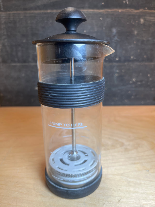 Ninja Easy Frother, a manual milk foamer with a PUMP TO HERE mark, designed to froth hot or cold milk directly in the glass.