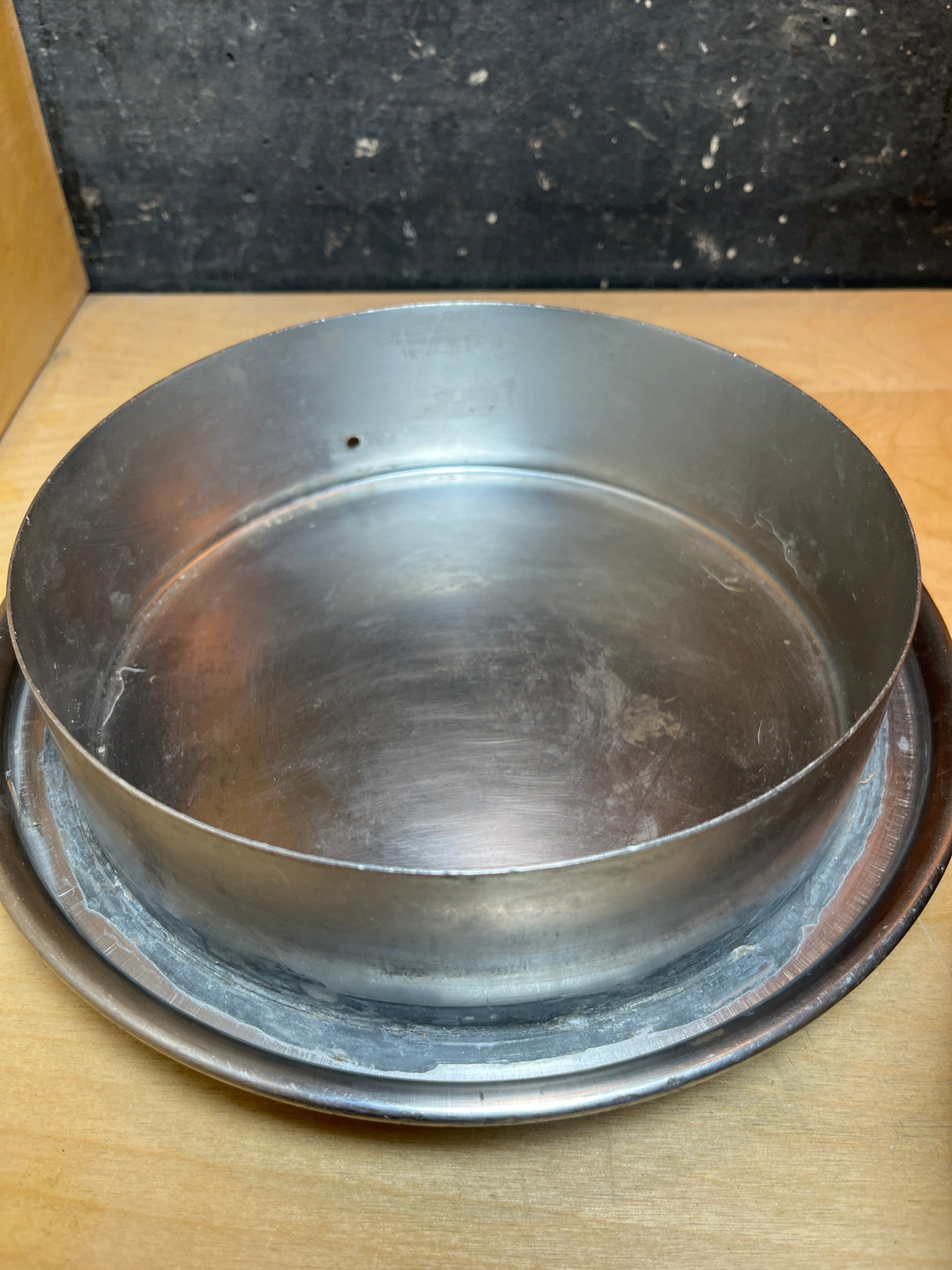 Vintage John Wood Young’s Dairy stainless steel milk can, designed as a round metal baking ring inside a shallow pan, ideal for molding cakes and desserts.