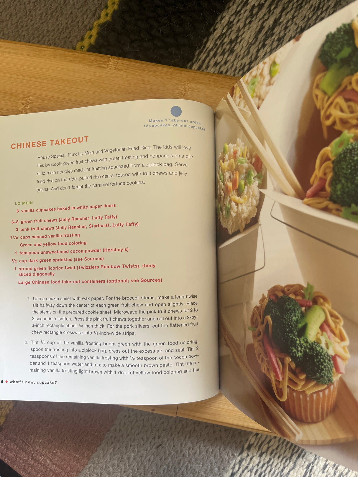 Open cookbook What’s New, Cupcake? showcasing a recipe page with a bowl of noodles and broccoli, highlighting creative culinary ideas.