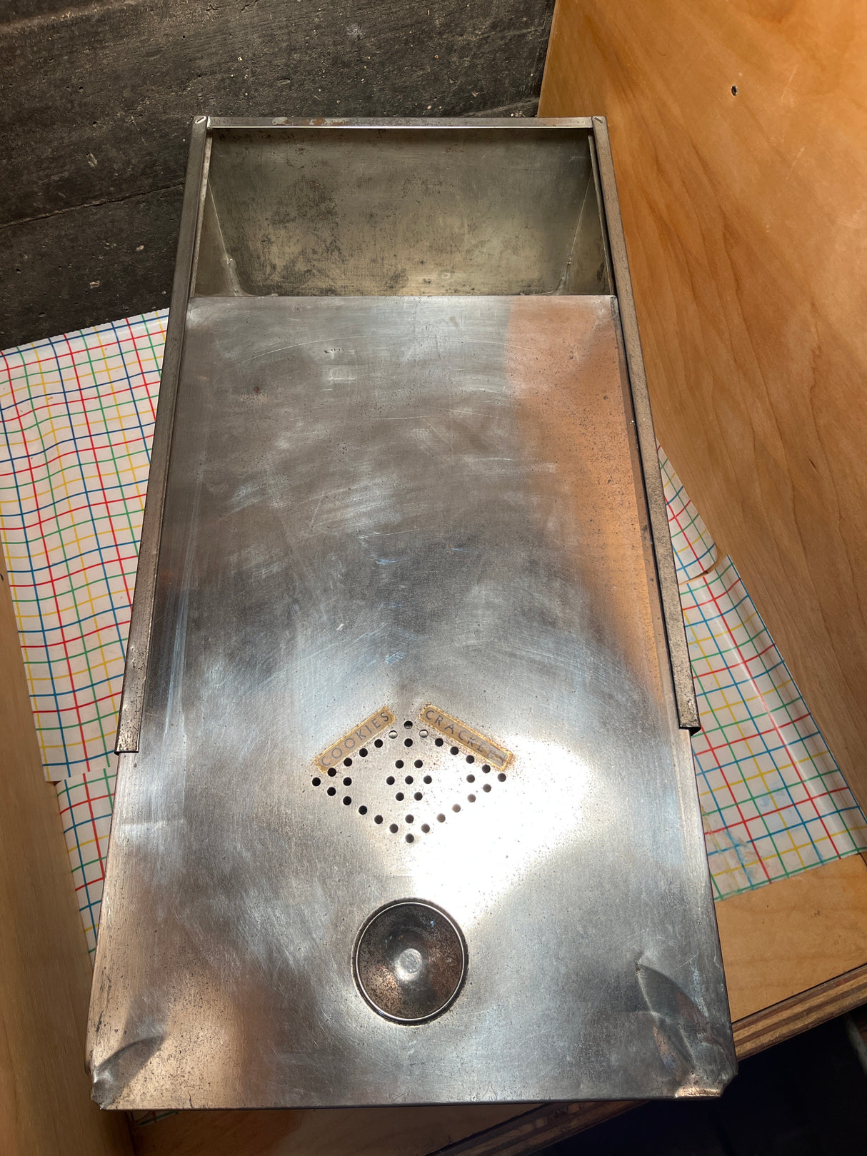 Antique steel bread box drawer insert with sliding lid, featuring perforated vents and original handmade labels, ideal for storing dry pantry goods.
