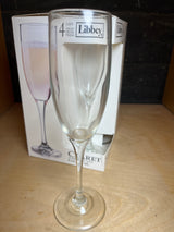 Libbey set of 4 champagne claret glasses displayed with retail box, featuring clear glass flutes designed for enjoying champagne or claret.