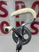 Close-up of the Vintage Rival handheld manual mixer model 571, showcasing its ergonomic handle, emphasizing quality craftsmanship and manual operation for precise mixing control.