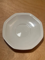 Octagonal salad plate from the Savoir Vivre Maison Blanche line, featuring subtly faceted edges, resting on a wooden surface.