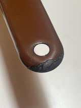 Tan and brown enameled sauce pot with a handle notch for hanging; features a small chip on the handle's end.
