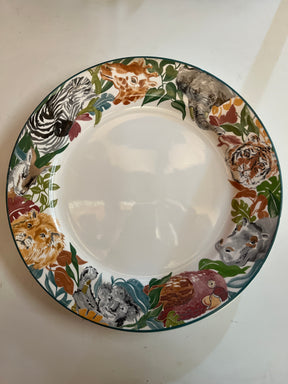 Jungle Fever dinner plate by Deborah Mallow for Sango 3033, featuring animal heads like giraffe, elephant, and zebra around its rim.