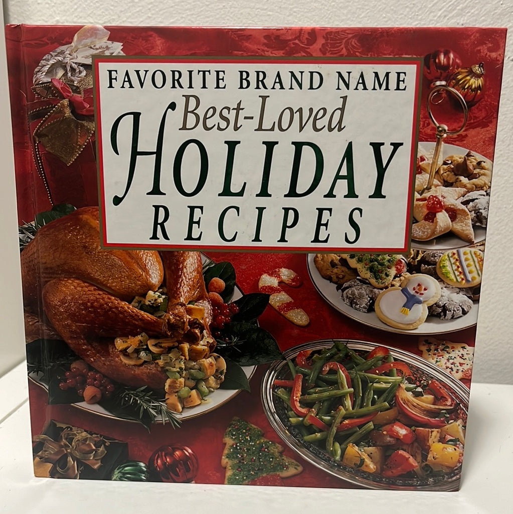 Favorite Brand Name Best-Loved Holiday Recipes book cover featuring festive food, Christmas cookies, vegetables, and a turkey. From Spoons Kitchen Exchange.