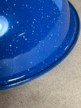 Blue speckled enamelware lid, showcasing a glossy white-speckle pattern and slightly chipped rim, highlighting its durable, vintage charm for camping or cookouts.