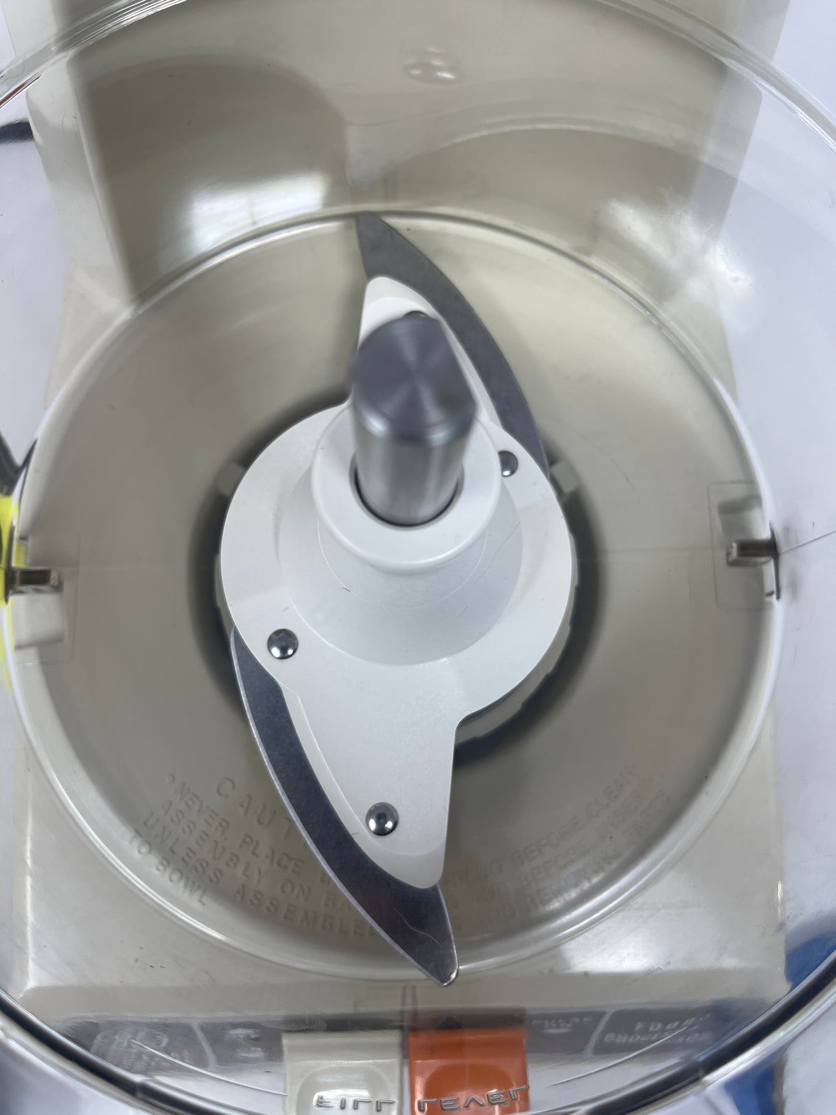 Close-up of Vintage GE food processor 420A D5FP1, highlighting the slicer/grater disc and its 4-cup capacity, designed for efficient meal prep.