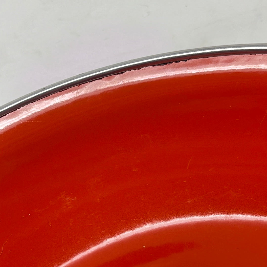 Close-up of a bright red enamel Paella Pan from the 1960s-1970s, showcasing its excellent condition with minimal edge wear.