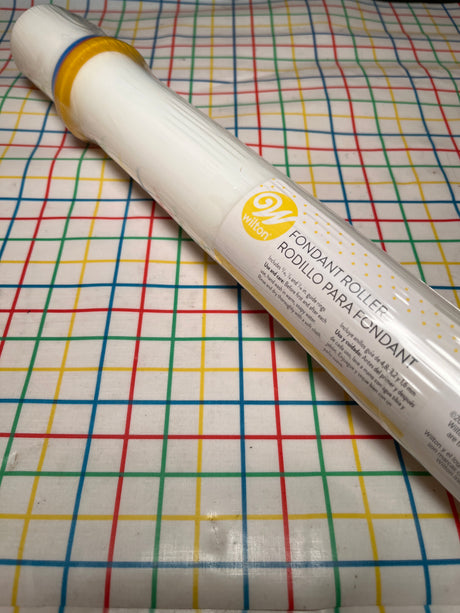 Fondant roller with guide rings - Wilton new in packaging, shrink-wrapped on grid-patterned surface; ideal for even fondant or dough rolling.