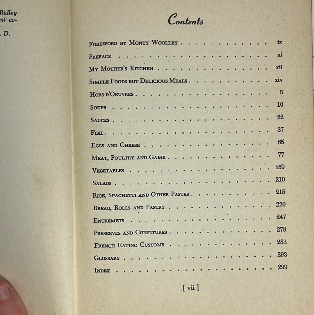 Louis Diat's Home Cookbook: French Cooking for Americans, featuring recipes from the French countryside, is shown open with visible handwritten notes.