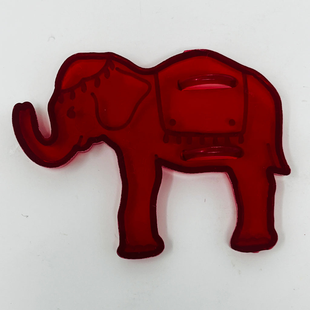 Red plastic mid century elephant cookie cutter with face, some with Crown logo.
