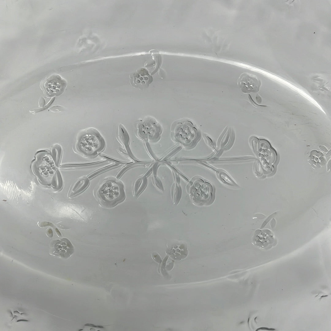 A large clear glass baking dish with lid featuring a floral motif design, perfect for elevating your potluck game.