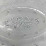 A large clear glass baking dish with lid featuring a floral motif design, perfect for elevating your potluck game.