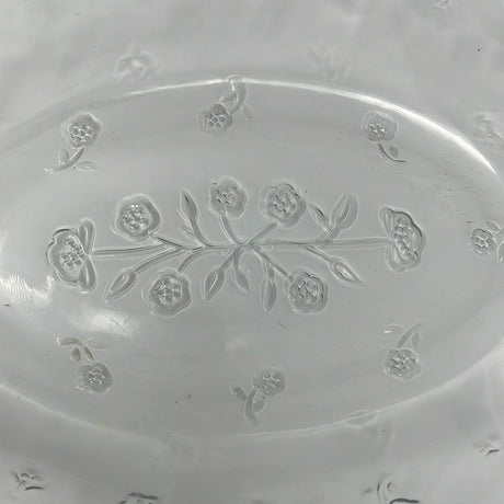 A large clear glass baking dish with lid featuring a floral motif design, perfect for elevating your potluck game.