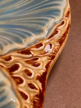 RARE French majolica oyster plate with a blue-green leaf-vein pattern, brown-tan border, and a small chip exposing white clay.