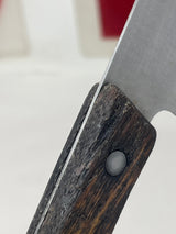 Vintage santoku chef’s knife with a 5.75” steel blade and a wood handle, showcasing its expert precision and durability. The handle has a small chip.