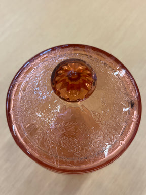 RARE Jeanette Depression glass pink floral poinsettia candy jar with lid, featuring a faceted footed base and ornate floral motifs, in good condition with a minor lid chip.