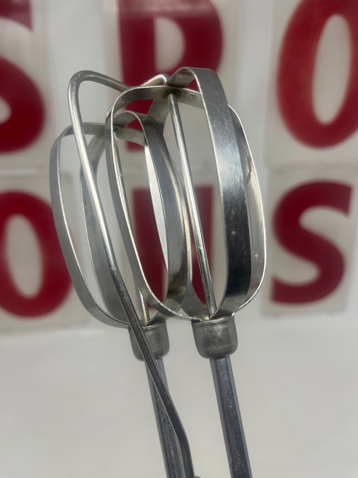 Close-up of the Vintage Rival handheld manual mixer model 571, showcasing its durable metal components, perfect for precise control in baking tasks.