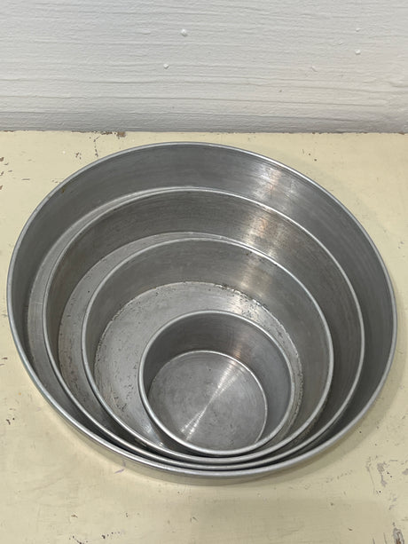 Set of 4 Aluminum Vitality by Mirro four-tier wedding cake pans, showcasing nested, round, metal construction for superior baking performance and vintage charm.