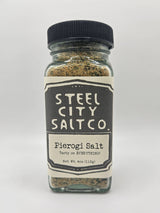 NEW Pierogi Salt! Square glass jar with black lid, filled with herb-flecked seasoning, labeled Steel City Salt Co. Pierogi Salt – Tasty on EVERYTHING!