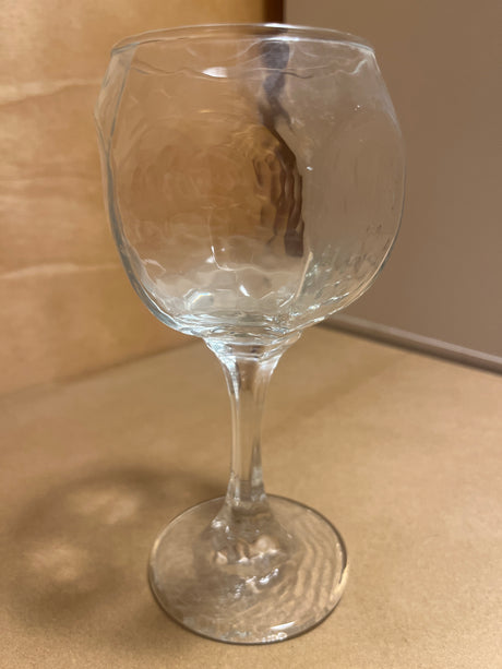 Libbey Chivalry glassware featuring a hammered-texture bowl, elegantly displayed upright on a countertop, showcasing its unique design and craftsmanship.