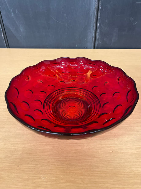 Imperial Glass Co. ruby red thumbprint footed serving bowl with a ring motif base and wavy edges, showcasing a unique design and craftsmanship.
