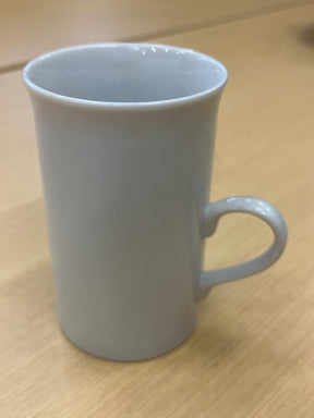 Tall ceramic white coffee mug with a smooth finish and delicate, modern handle, perfect for everyday use.