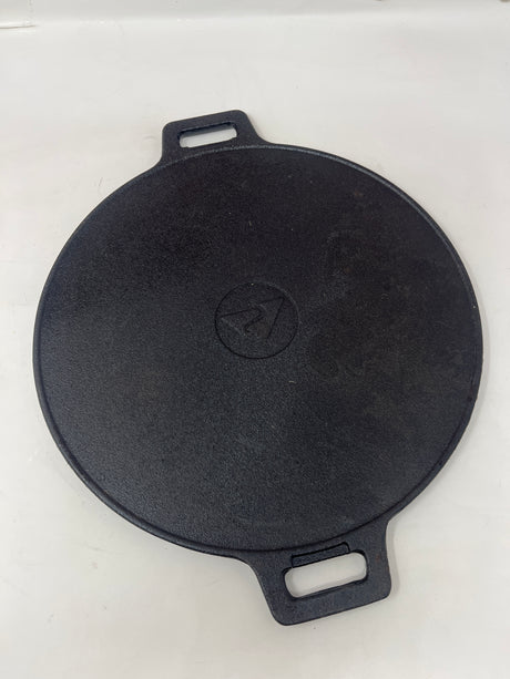 Cast iron ridged grill pan with handles, ideal for gas stoves and outdoor grills, ensures even searing and heat retention for paninis and veggies.