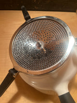 Stainless Steel Food Mill For Purees, Silver and White - OXO Good Grips, features a side-handled design with non-slip legs and a removable infuser lid.