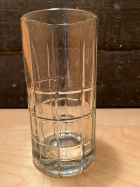 Anchor Hocking Manchester Drinking Glasses feature a textured grid pattern on durable, clear glass, perfect for everyday use and versatile for any beverage.