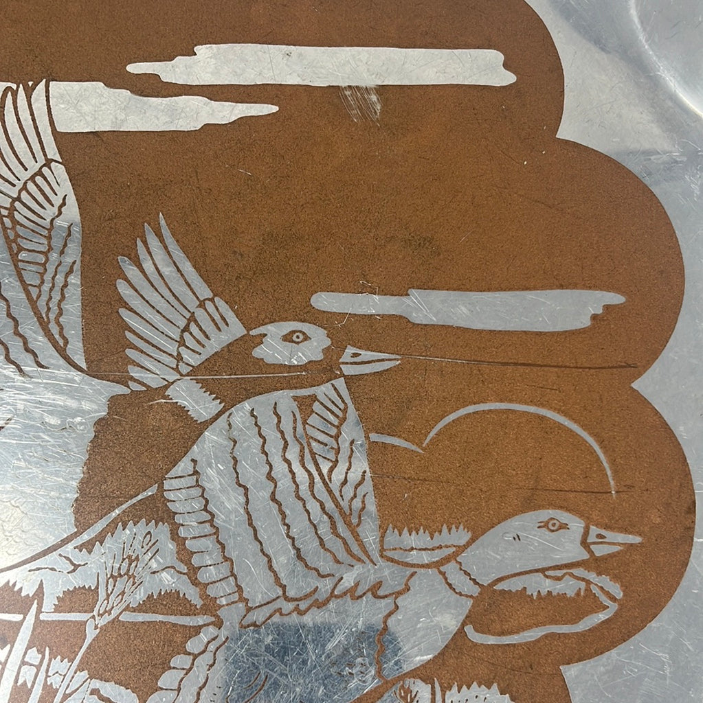 Metal serving tray featuring a majestic mallard duo rising from water, with a scalloped edge. Visible scratches and scuff marks, no cracks.