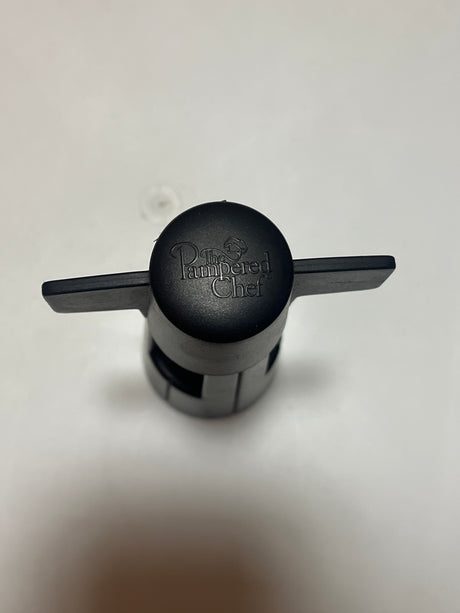 A sleek wine bottle opener from The Pampered Chef, featuring a sturdy handle and a corkscrew mechanism designed for effortless uncorking.