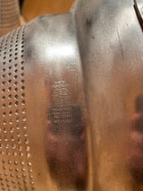 Close-up of Tiny pointy cone sieve strainer - aluminum, showing perforated holes, “Wear-Ever Aluminum” stamp, and patent numbers. Handle securely attached; slight cone tip dent visible.