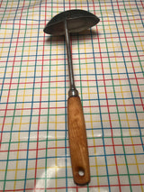 Stainless steel ladle with wood handle - EKCO Eterna, featuring a wide base and durable design for easy scooping in cooking tasks.