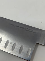 Simply Calphalon 7” Santoku knife, ideal for chopping crispy produce and herbs, displayed with a sharp blade and ergonomic handle.