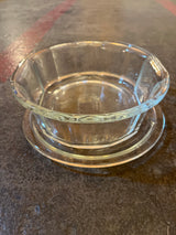 Oval casserole baking dish with lid - PYREX 804-B, showcasing an octagonal clear glass design on a matching saucer, emphasizing its durable borosilicate glass construction.