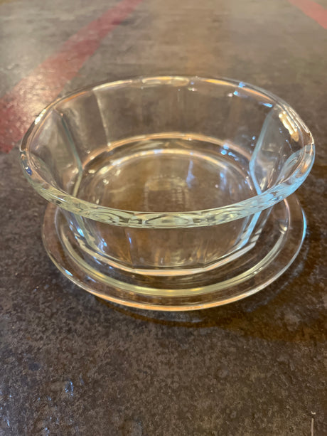 Oval casserole baking dish with lid - PYREX 804-B, showcasing an octagonal clear glass design on a matching saucer, emphasizing its durable borosilicate glass construction.