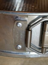 Close-up of the latch on a RARE Cold War springform cake pan - 12” tin made in W. Germany, highlighting the “Made in W-Germany” stamp.