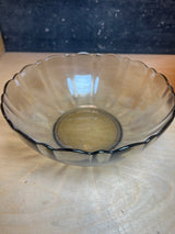 Arcoroc smoky glass set features a scalloped rim with vertical ridges, shown here as a shallow bowl on a wood surface.