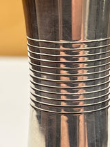 Towle sterling silver jigger shot glass with a sleek midcentury design, featuring small dents on the edges, enhancing its vintage charm.