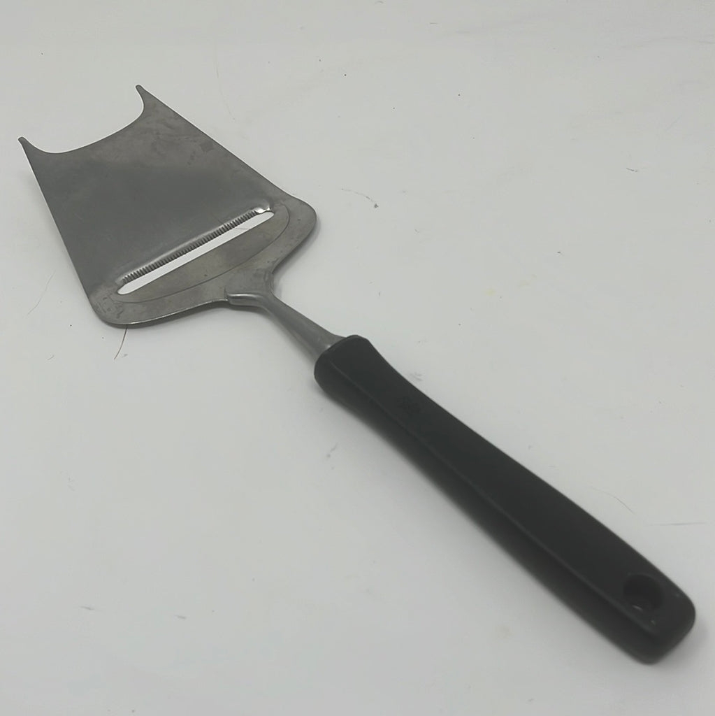 WMF vintage cheese slicer with black handle, a sharp blade and two prongs for easy cheese slicing.