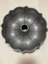Northland Aluminum Products Inc. Original Bundt Cake pan (vintage Nordic Ware), fluted, ring-shaped, viewed from above, showcasing its durable 1950s aluminum design for baking.