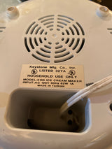 Automatic ice cream maker - Deni 5100, showing underside with housing vents, UL safety marks, and cord storage compartment, designed for quick homemade frozen desserts.