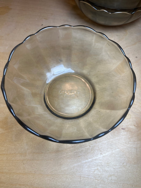 Arcoroc smoky glass salad bowl with scallop edges, translucent amber tint, and embossed “Arcopal France” mark, shown on a wooden surface. Part of an 8-bowl set.