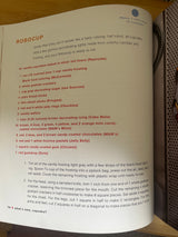 Cover of the cookbook What’s New, Cupcake? showcasing creative dessert recipes, featuring visible text and a page displaying a recipe.