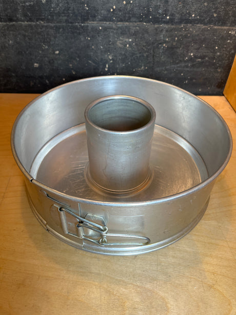 Springform 3-piece angel food cake pan - vintage Manitowoc aluminum, featuring a removable base and side spring-clip latch, ideal for airy cakes with central tube support.