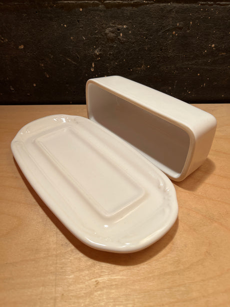 Covered white ceramic butter dish by Pfaltzgraff, featuring a rectangular lid beside its matching base, ideal for serving or storing butter or cheese.