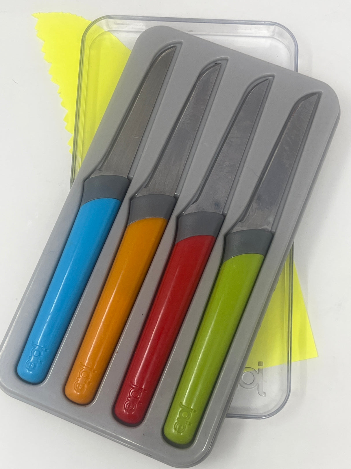 Joie set of 4 garnishing knives with colorful handles in a protective hard case, ideal for intricate garnishes and herb preparation.