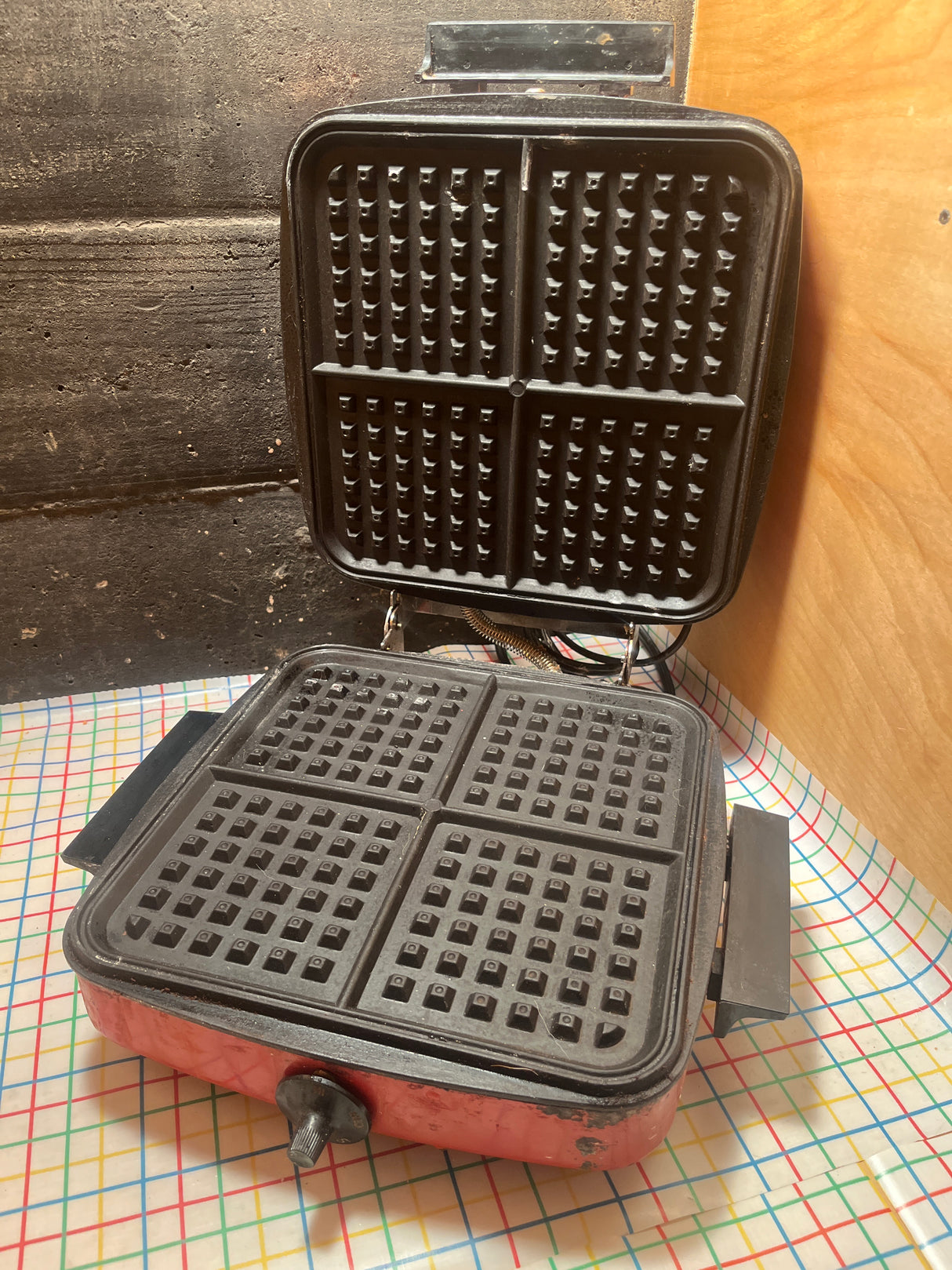 Red vintage Wards Signature BE-46029 waffle iron, open to show grid-patterned plates for Belgian waffles; tested, adjustable temperature, avoid harsh cleaners to maintain paint.
